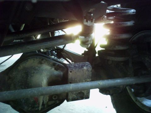1986 Ford Bronco - Close-up view of the undercarriage components, including the rear axle and suspension system.