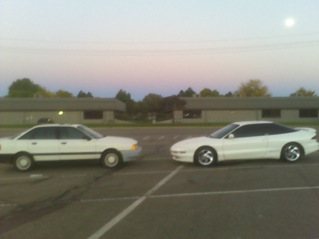 White Ford Probe and another white sedan parked in a lot