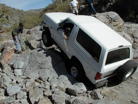 1993 Ford Bronco - White 1993 Ford Bronco tackling a difficult rocky terrain.