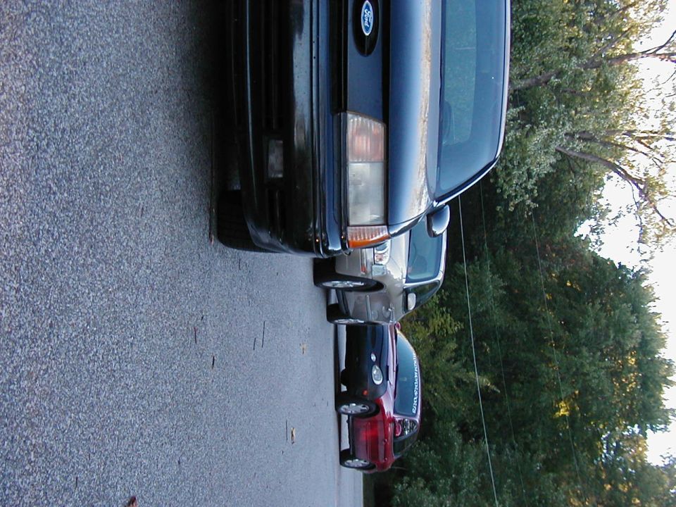 Black 1990 Ford Taurus front end, parked on asphalt