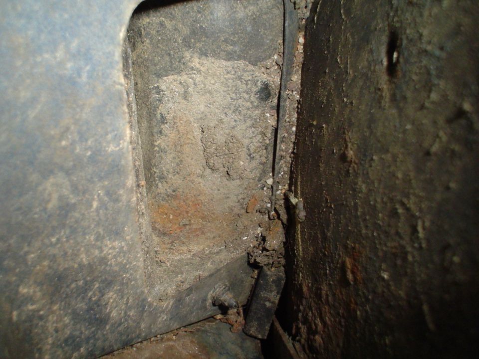 Close-up of rusted interior body panel and frame