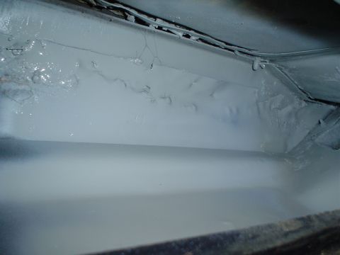 1984 Ford Bronco - Underbody of a vehicle showing a grey primer application.