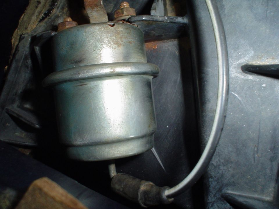 close-up of a metal fuel pump relay with wires attached