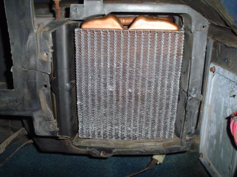 1984 Ford Bronco - The heater core is visible within its housing, showing the metal fins and copper tubing.