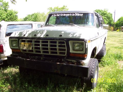 1979 Ford Bronco - This 1979 Ford Bronco is seen from the front, a white body, black roof, and a humorous sticker on the windshield.