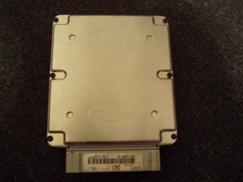 1993 Ford Taurus - A Ford engine control module is shown, embossed Ford logos and a label with a barcode.