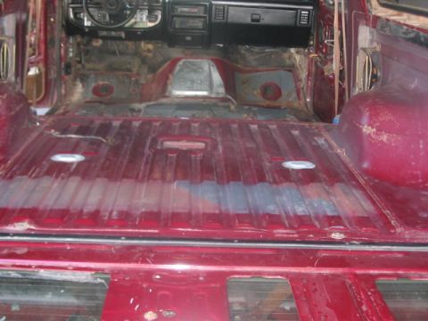 1991 Ford Bronco - The interior of the vehicle has been stripped down to the metal, revealing the floor pan and dashboard area.