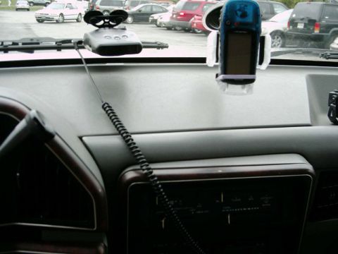 1988 Ford Bronco - Interior view of a vehicle's dashboard, showing aftermarket accessories like a GPS and radar detector.