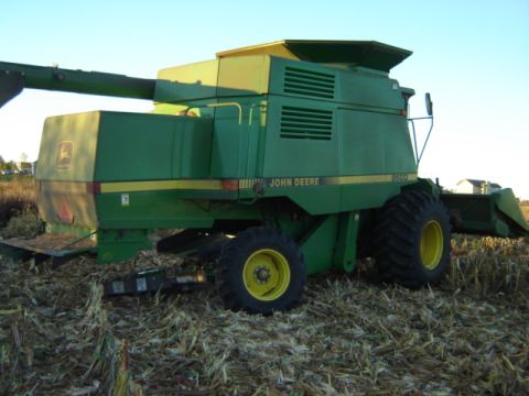 1992 Ford Bronco - A John Deere combine harvester sits in a field after the harvest.