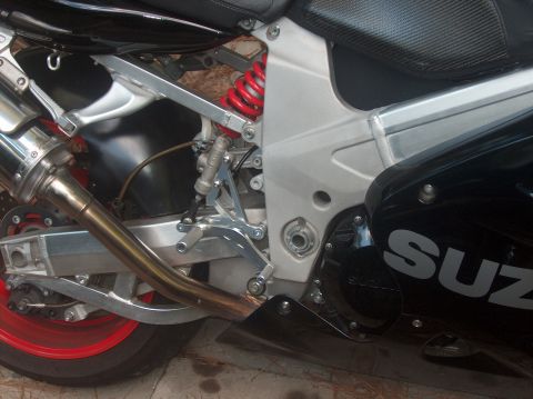 2002 Suzuki TL1000R - A detailed view of a Suzuki motorcycle's mechanical components, including the exhaust and suspension system.