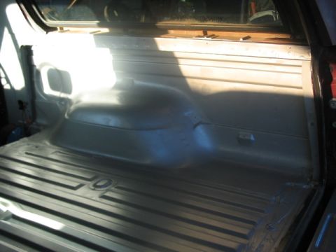 1991 Ford Bronco - The interior cargo area of a vehicle shows a ribbed floor and a molded side panel, suggesting it might be a truck or SUV.