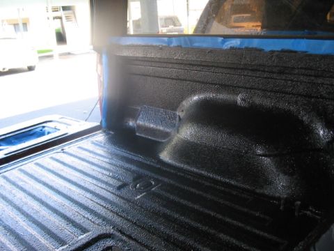 1991 Ford Bronco - Newly applied black spray-on liner protects the ribbed floor of a truck bed.