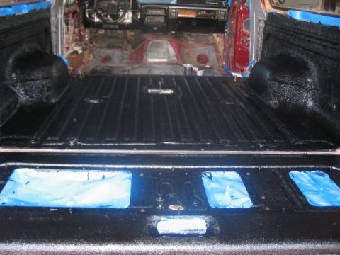 1991 Ford Bronco - Interior of a 1991 Ford Bronco after applying black spray-on bed liner to the cargo area.
