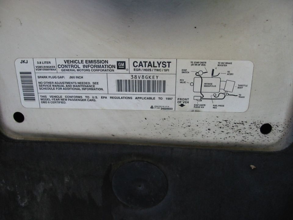 GM 3.8 liter VECI emission label with .060 inch spark plug gap and vacuum hose routing diagram