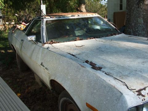 1966 Ford Ranchero - This weathered 1972 Ford Ranchero shows significant rust and debris, indicating it has been neglected.