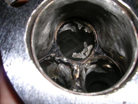 1996 Ford Probe - Damaged exhaust manifold showing internal wear and tear.