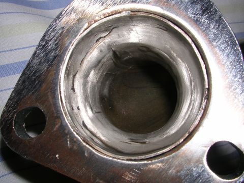 1996 Ford Probe - This is a close-up view of a metal exhaust header flange, showing internal wear and damage.