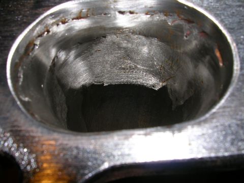 1996 Ford Probe - Close-up view of the inside of an engine cylinder head, showing wear and deposits.