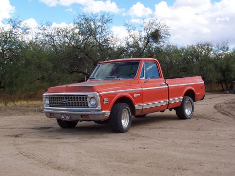 1972 Chevrolet C/K Pickup - This pickup truck has a distinctive grille and chrome trim, suggesting a specific model year.
