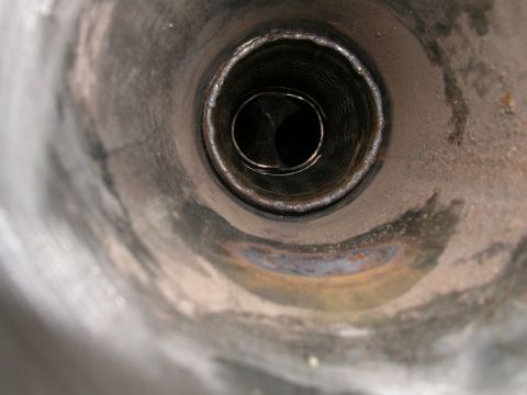 1996 Ford Probe - The interior of a metal exhaust pipe is shown, revealing its construction and wear.