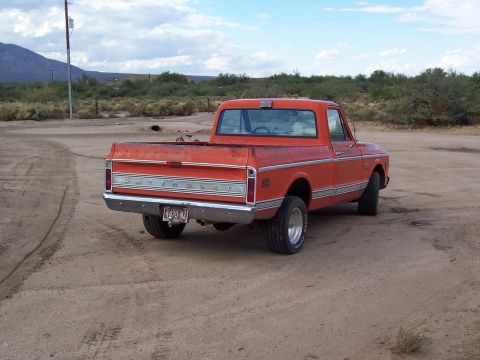 1972 Chevrolet C/K Pickup - This 1972 Chevrolet C/K Pickup is shown from a rear three-quarter view in an outdoor, dusty setting.