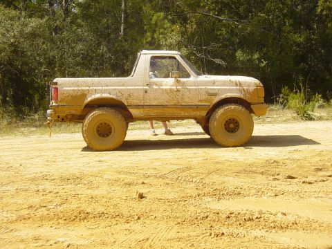 1989 Ford Bronco - This SUV is covered in mud after driving off-road.