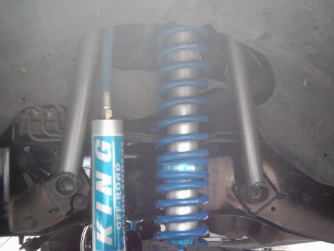 1978 Ford Bronco - Close-up view of aftermarket suspension parts, including a King Off-Road shock absorber and coilover.