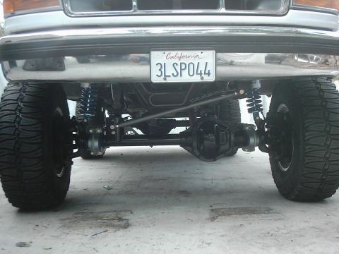 1978 Ford Bronco - Close-up view of the front axle and suspension system on a modified truck.