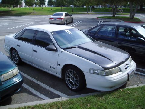 1993 Ford Taurus - This sedan has a custom hood and racing numbers on the windshield.