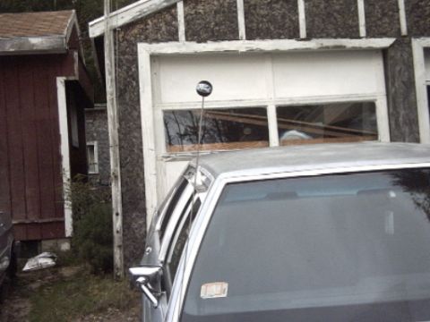 1991 Ford Crown Victoria LTD - A 1991 Ford Crown Victoria LTD is parked in front of a garage with a white door.
