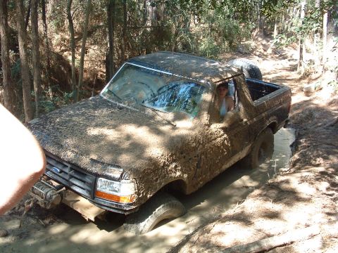 1993 Ford Bronco - This 1993 Ford Bronco is deep in the mud while off-roading on a wooded trail.