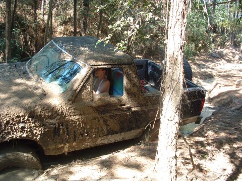 1993 Ford Bronco - Muddy 1993 Ford Bronco navigating a difficult off-road trail.