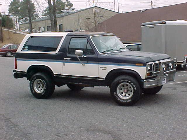 Blue and white 1985 Ford Bronco 3/4 front view