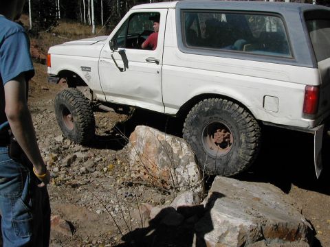 1994 Ford Bronco - This 1994 Ford Bronco is shown off-roading over rocks on a dirt trail.