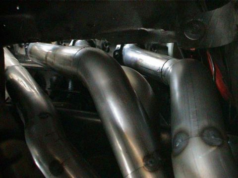 1979 Ford Bronco - Close-up view of custom exhaust headers installed on an engine.