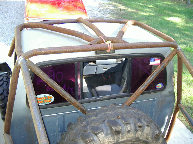 Roll cage on a truck with purple tinted rear window showing interior