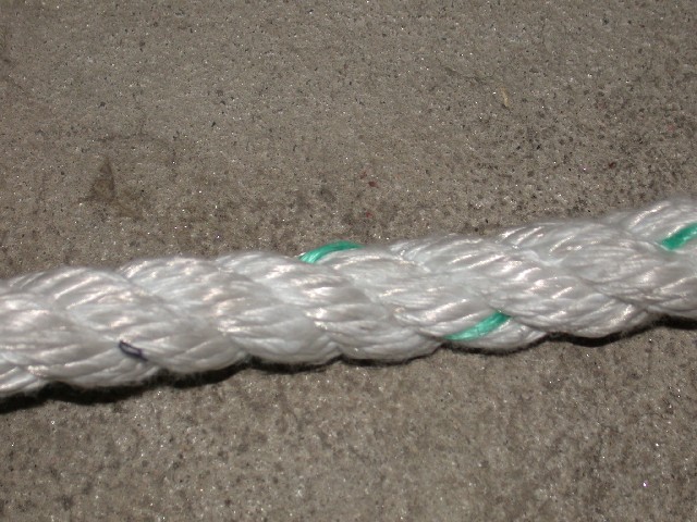 Close-up of white braided rope with green strands