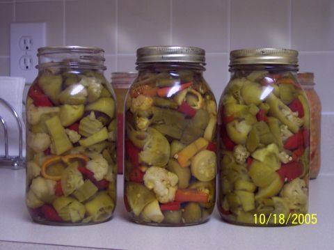 1987 Toyota 4Runner - Jars filled with pickled vegetables, including cauliflower, peppers, and cucumbers, sit on a kitchen counter.