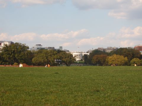 1988 Ford Bronco - A view of the White House on a partly cloudy day, with people enjoying the park.