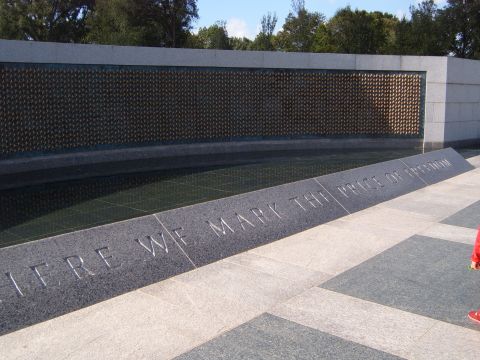 1988 Ford Bronco - A memorial wall with inscribed text and a reflection pool is shown under a clear sky.