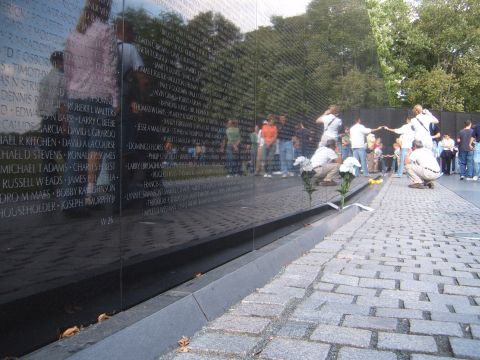 1988 Ford Bronco - Visitors at the Vietnam Veterans Memorial Wall in Washington D.C. observe the names etched into the granite.