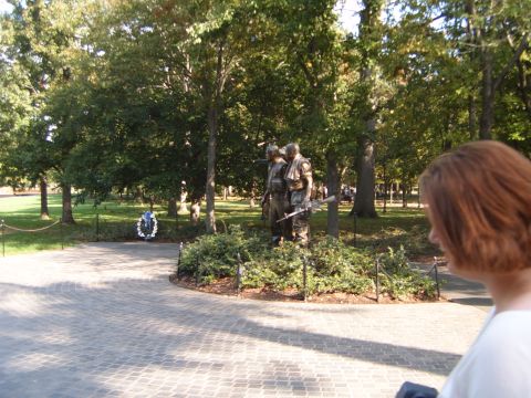 1988 Ford Bronco - A memorial scene with statues of soldiers and a wreath, set in a park-like environment.