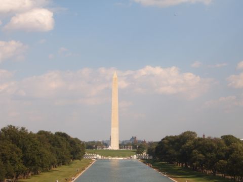 1988 Ford Bronco - The Washington Monument stands tall over the Reflecting Pool, with trees and clouds in the background.