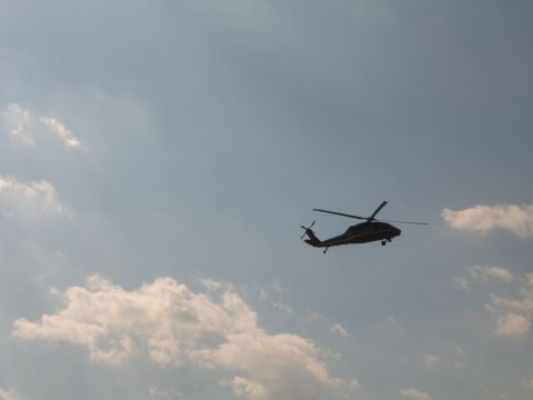 1988 Ford Bronco - A helicopter is seen flying in the sky with clouds in the background.