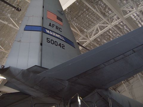 1988 Ford Bronco - Tail section of a military transport aircraft with US flag and unit markings visible.