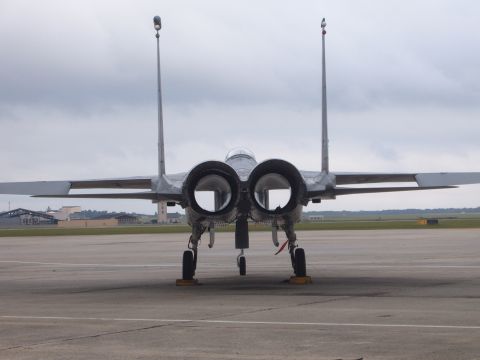 1988 Ford Bronco - This F-15 Eagle fighter jet is parked on an airfield, viewed from directly behind.