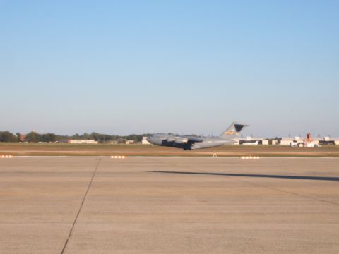 1988 Ford Bronco - A large military cargo plane is on the tarmac at an airport.