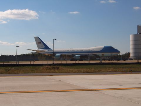 1988 Ford Bronco - A Boeing 747 aircraft, identified as "United States of America", is parked on an airport tarmac under a blue sky.