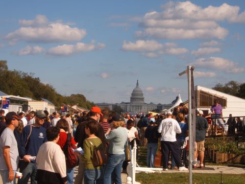 1988 Ford Bronco - A large gathering of people is seen with the U.S. Capitol building visible in the distance under a cloudy sky.