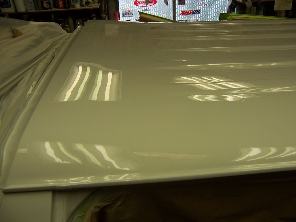 White vehicle roof with reflections of fluorescent lights